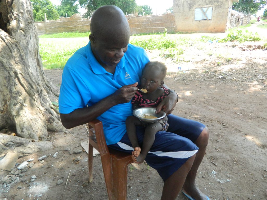 Malnourished baby being fed